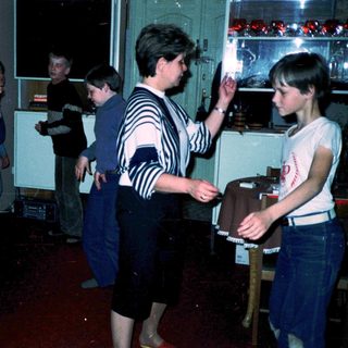 People playing arcade games in a retro bar.
