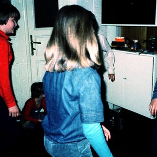 Four children playing indoors at night.