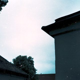Rainy evening with houses and trees.