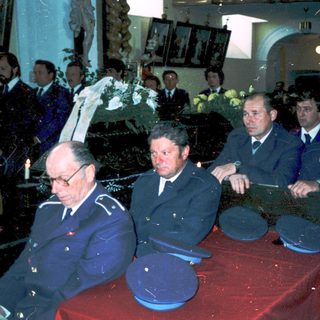 Funeral ceremony with military officials and dignitaries.