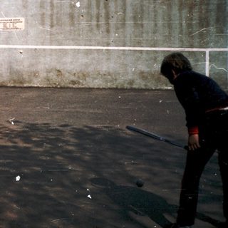 People playing frisbee in an urban park area.