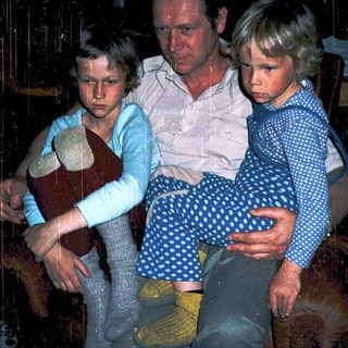 Family indoors during rainy weather.