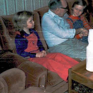 Family enjoying holiday gift opening indoors.