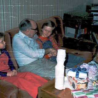 Family enjoying holiday gift opening indoors.