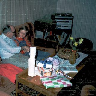 Family enjoying holiday gift opening indoors.