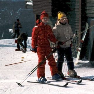 Skiers standing near ski lift station.