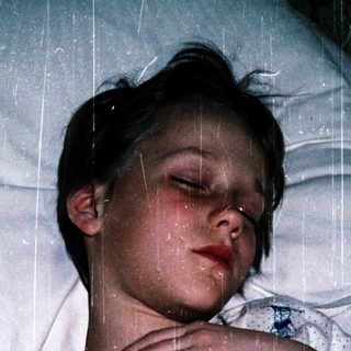 A person sleeping peacefully under rain.