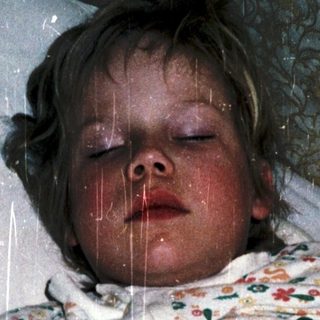 Child sleeping with rain shower on.