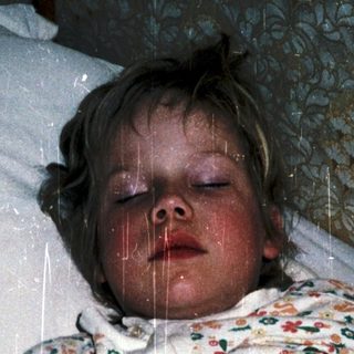 Child sleeping with rain shower on.
