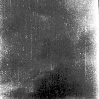 Rainy sky with vertical streaks from camera motion.