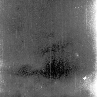 Blurry abstract shadow on textured surface.