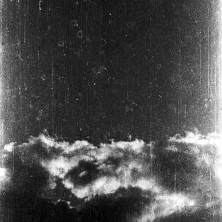 Dark sky with scattered, low-lying clouds.