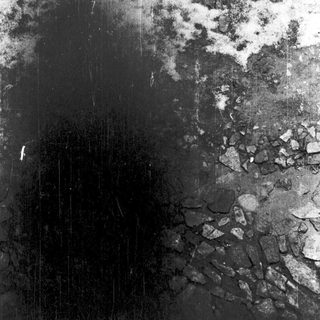 Cracked, charred surface with soot and ash.