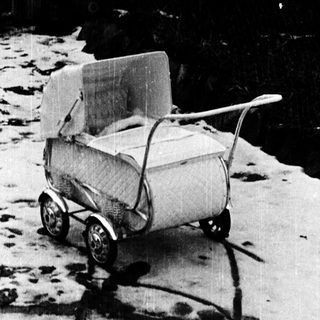 Old-fashioned wagon on snow-covered path.