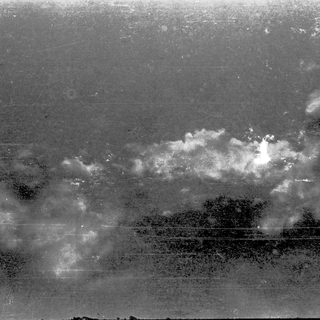 Misty landscape with distant bright light.