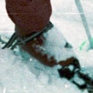 Two children skiing in snowy outdoor setting.