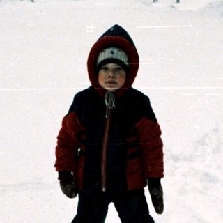 Child skiing on snow-covered slope.