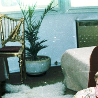 Child sitting in armchair during indoor snow play.