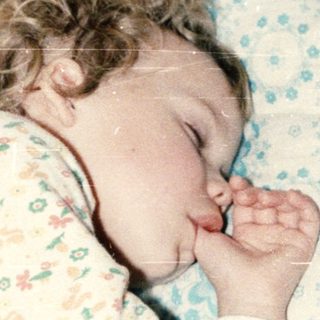 A baby peacefully sleeping in a crib.
