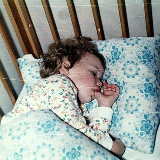 A child peacefully sleeping in a crib.