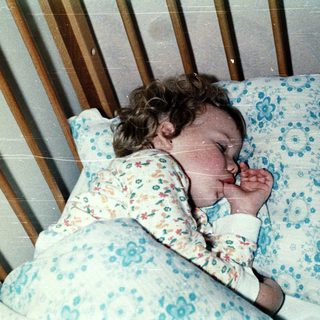 A child peacefully sleeping in a crib.