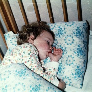 A child peacefully sleeping in a crib.