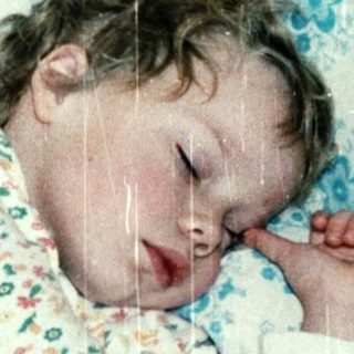 A child peacefully sleeping in a crib.