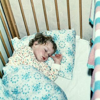 A child peacefully sleeping in a crib.