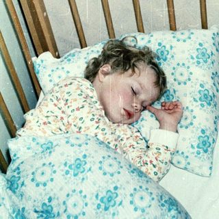 A child peacefully sleeping in a crib.