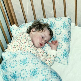 A child peacefully sleeping in a crib.