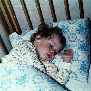 Baby sleeping peacefully in crib.