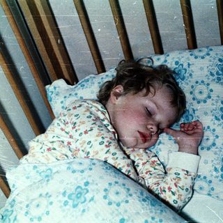 Baby sleeping peacefully in crib.