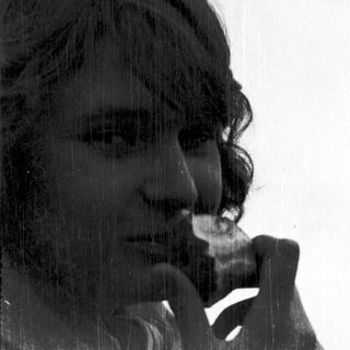 Person resting chin on hand in thoughtful pose.