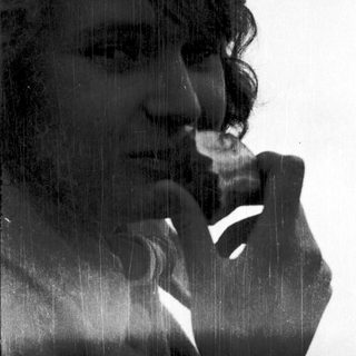 Person resting chin on hand in thoughtful pose.