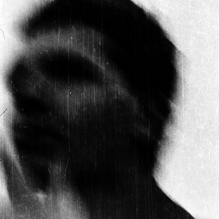 Silhouette of person against blurred light.