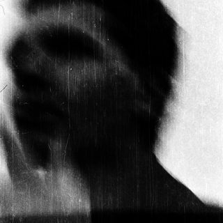 Silhouette of person against blurred light.