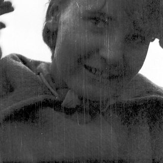 Person smiling while standing in rain.