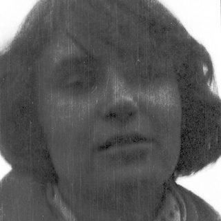 Rain-soaked person with blurred, wet hair.