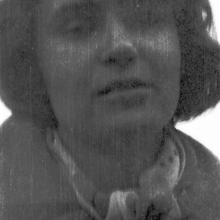 Rain-soaked person with blurred, wet hair.