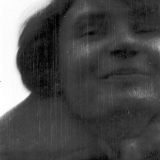 Person standing in rain with blurred face.