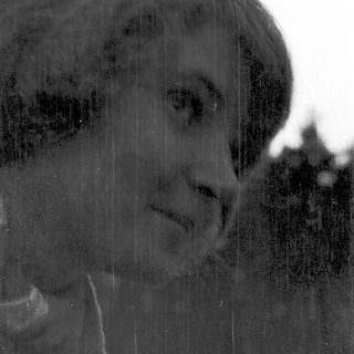 Silhouette of person in rain through window.