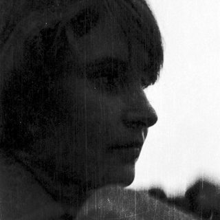 Silhouette of person against rain-soaked window.