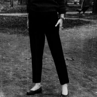 Woman standing outdoors in casual attire.
