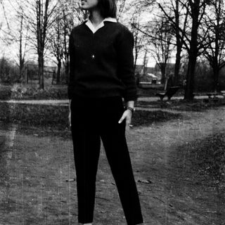 Woman standing outdoors in casual attire.