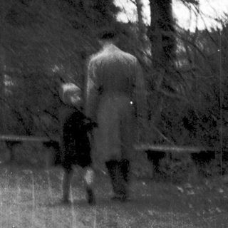 Two people walking in a snowy park.