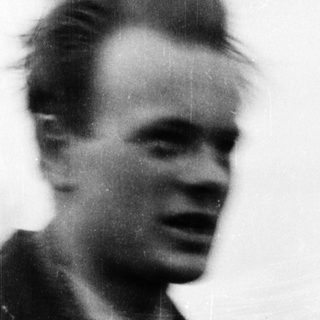 Blurred portrait of young man outdoors.