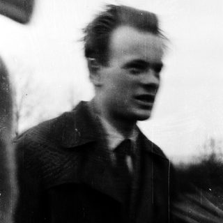 Blurred portrait of young man outdoors.