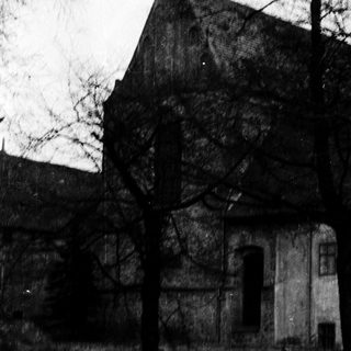 Historic stone church with steep gable roof.