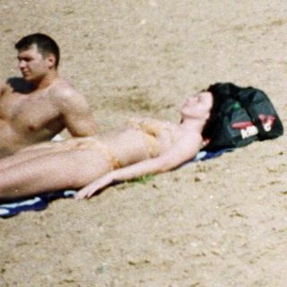 Family beach outing with children in sand.