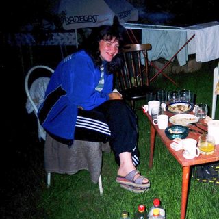 Two people enjoying outdoor evening meal together.